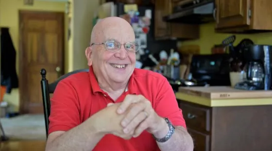Tom Silvia of Plymouth sits at his kitchen table